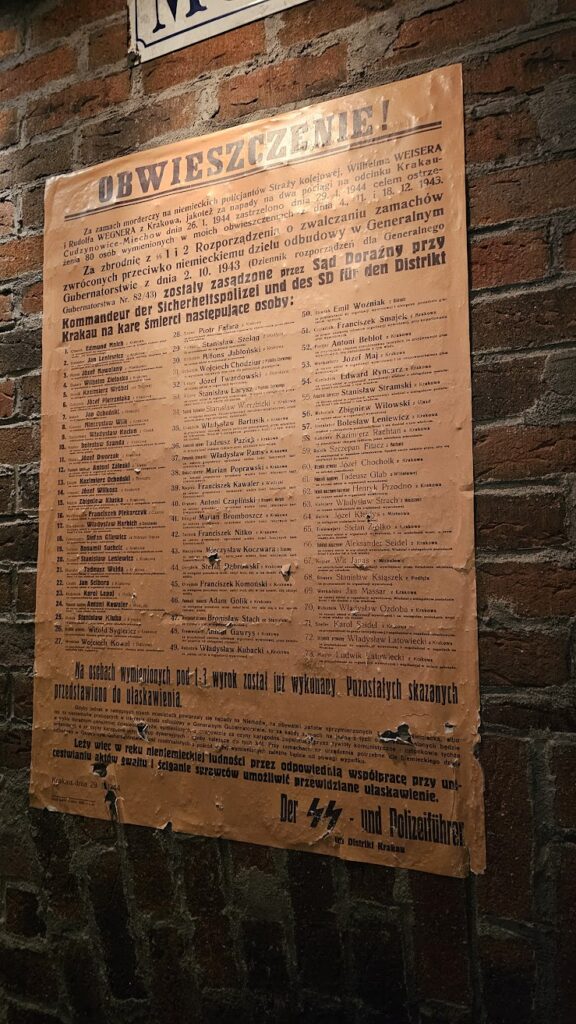 Reproduction of a 1944 Nazi announcement listing 80 Poles executed in retaliation for attacks on German police officers, displayed at the Oskar Schindler’s Factory Museum in Kraków.