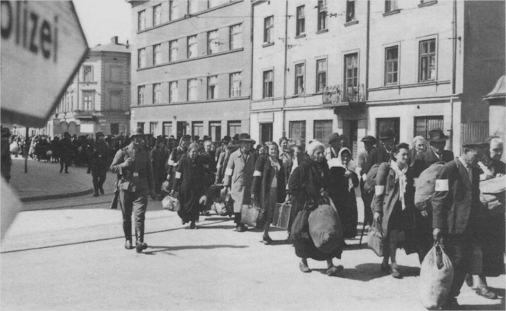 Jewish residents of the Kraków Ghetto being marched under SS guard during the liquidation in March 1943.